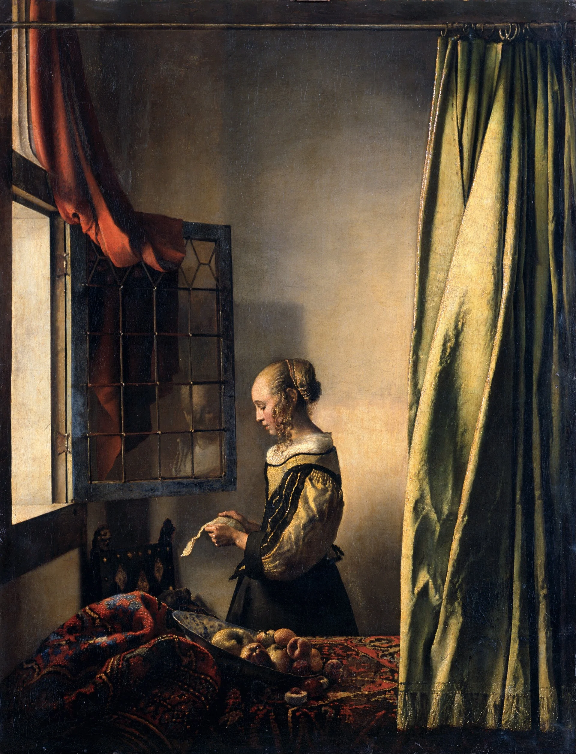 A letter at an open window: light and the outside world are drawn into the room, and the woman stands exactly on the border between them